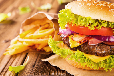 cheeseburger with tomato, lettuce, onion, and pickles served with french fries